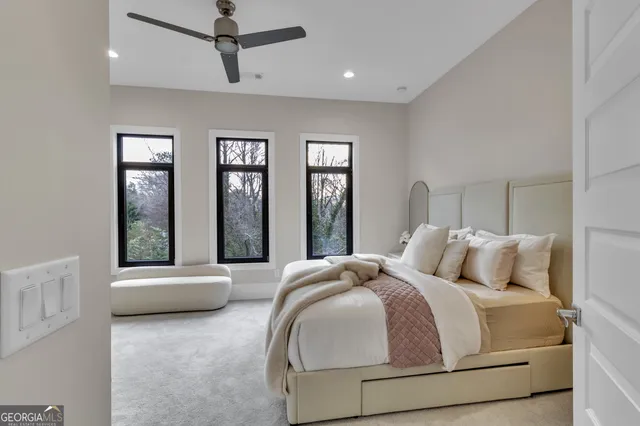 a bedroom with a bed and large window