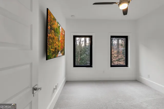 an empty room with windows and closet