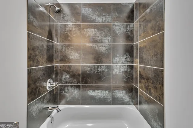 a bathroom with a bath tub and a sink