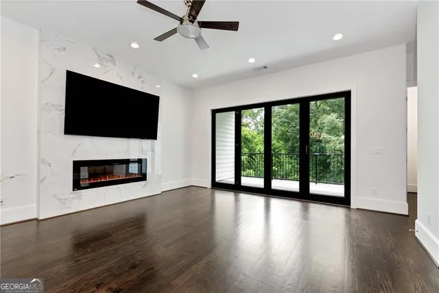 a view of a living room with a flat screen tv and a fireplace