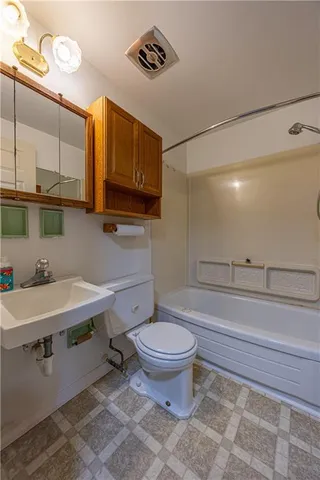 a bathroom with a sink a toilet and a mirror