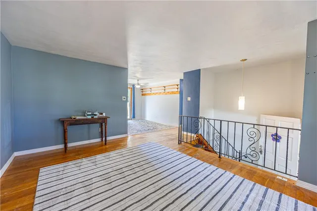 a bedroom with furniture and wooden floor