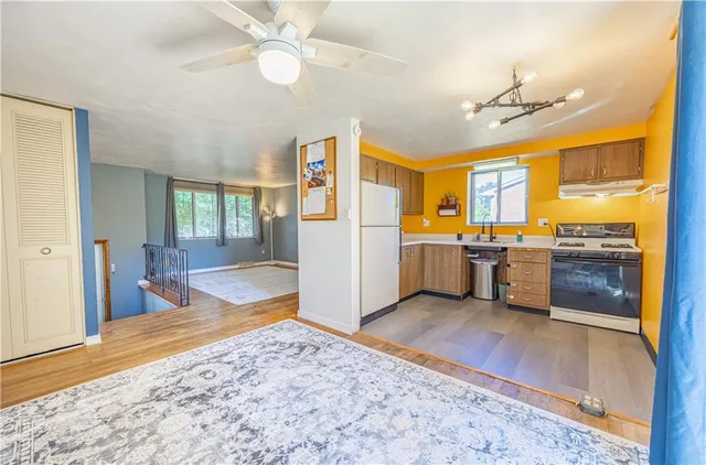 a view of a kitchen with wooden floor and a kitchen