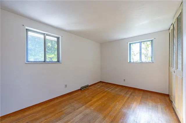 wooden floor in an empty room with a window
