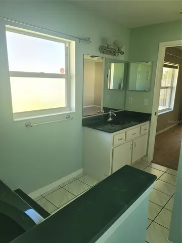 a bathroom with a shower and mirror