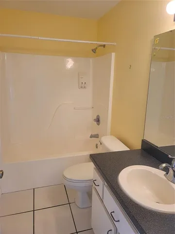 an empty room with fan and windows