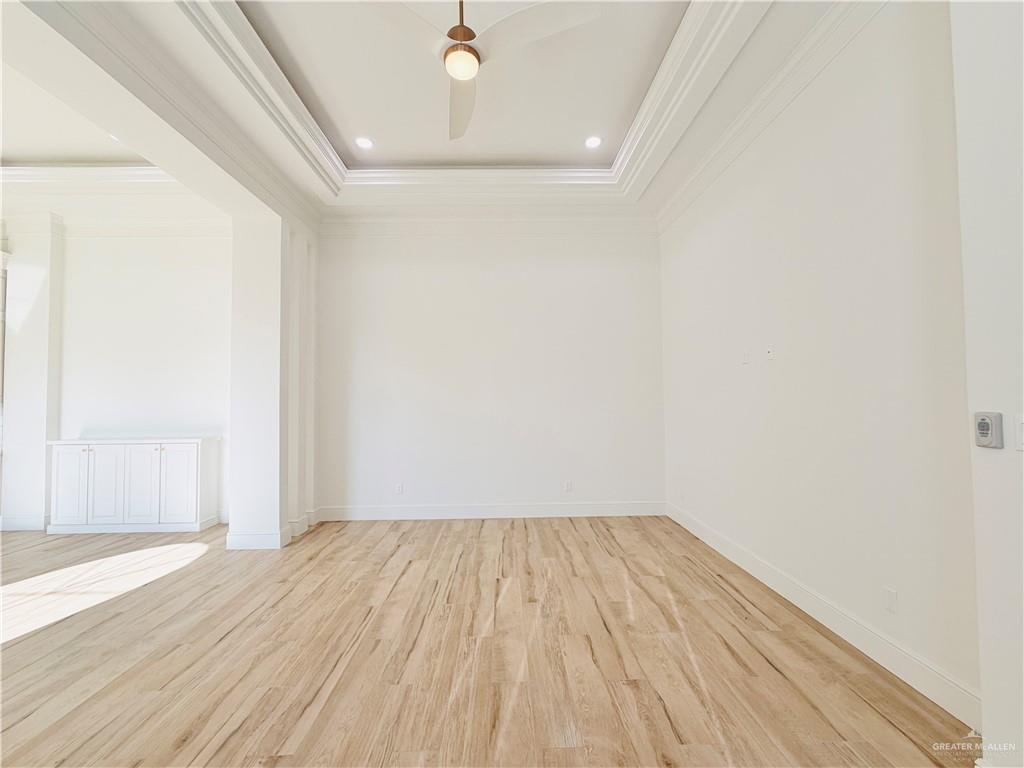 807 Ramirez Street Mission, TX 78573 - Photo 4 of 16 Living room with Recessed lighting, ceiling fan, crown molding, tray ceiling, wood tile flooring
