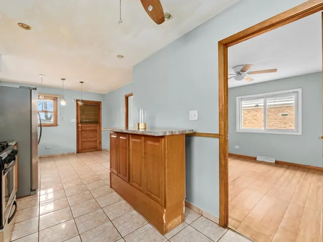 a view of a hallway with wooden floor and cabinet