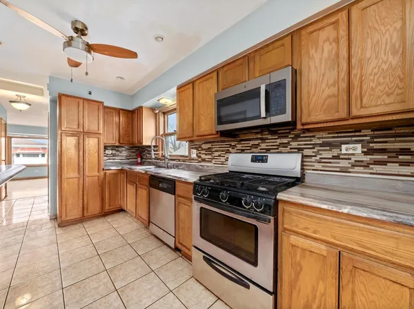 a kitchen with stainless steel appliances granite countertop a stove sink microwave and cabinets