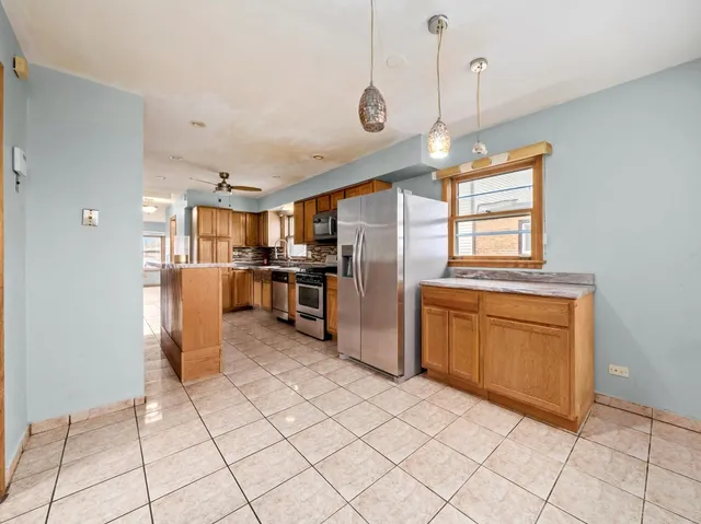a kitchen with stainless steel appliances granite countertop a refrigerator and microwave