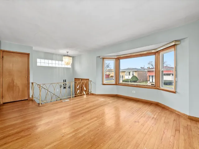 an empty room with fireplace and windows
