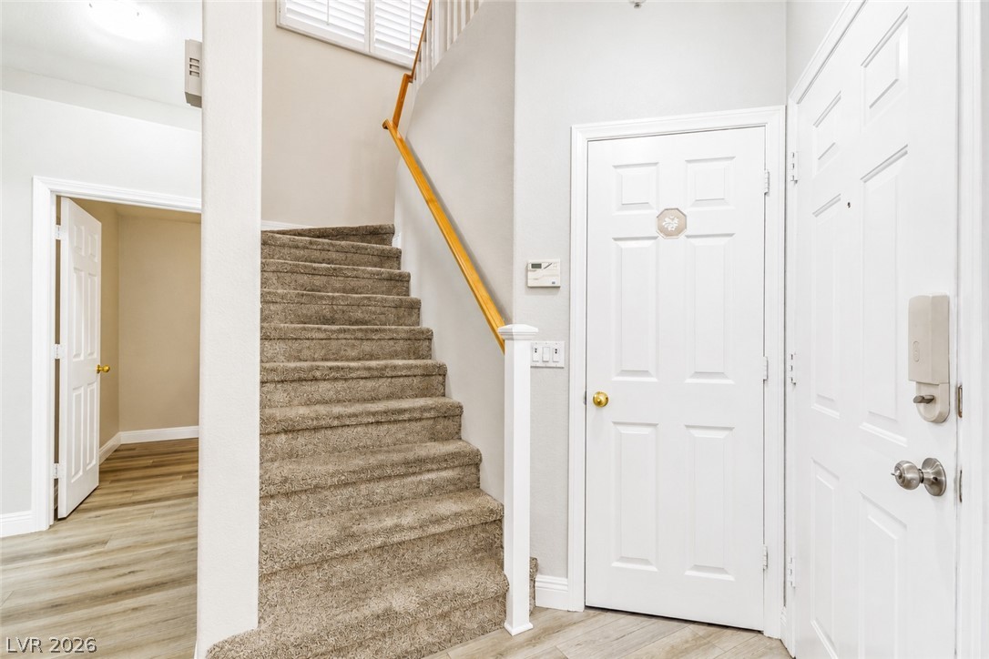 2278 Ramsgate Drive Henderson, NV 89074 - Photo 13 of 34 A welcoming entryway with a carpeted staircase leading to upper levels, offering both comfort and practical design.
