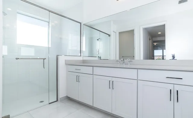 a bathroom with a granite countertop sink mirror and double