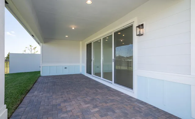 a view of an empty room with a fireplace and a large window