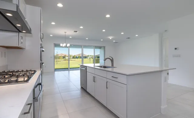 a kitchen with a sink appliances and cabinets
