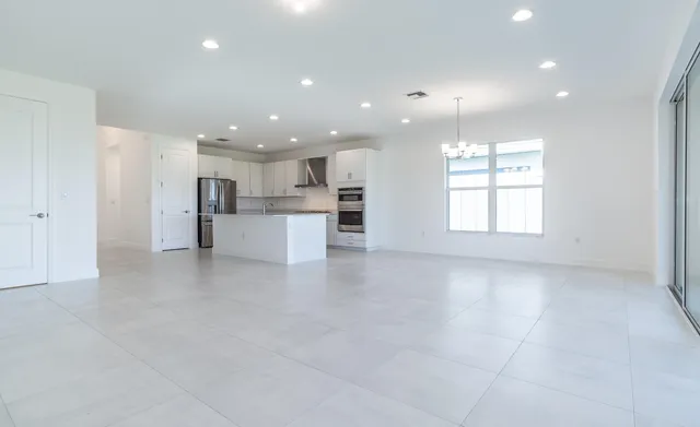 a view of a kitchen with a refrigerator and a window