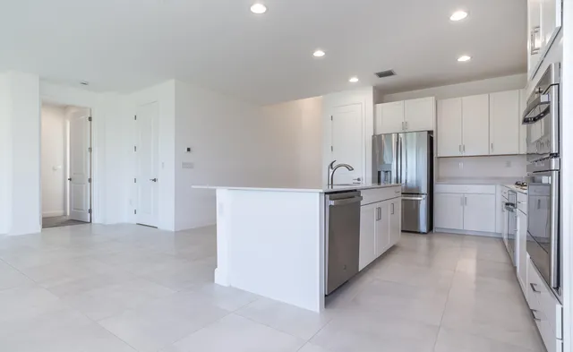 a kitchen with cabinets and stainless steel appliances