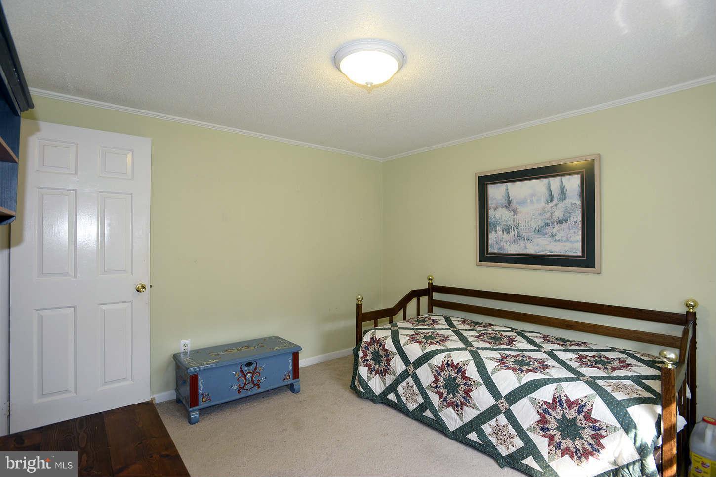295 North Clear Ridge Road Union Bridge, MD 21791 - Photo 14 of 17 a bedroom with bed and cupboard