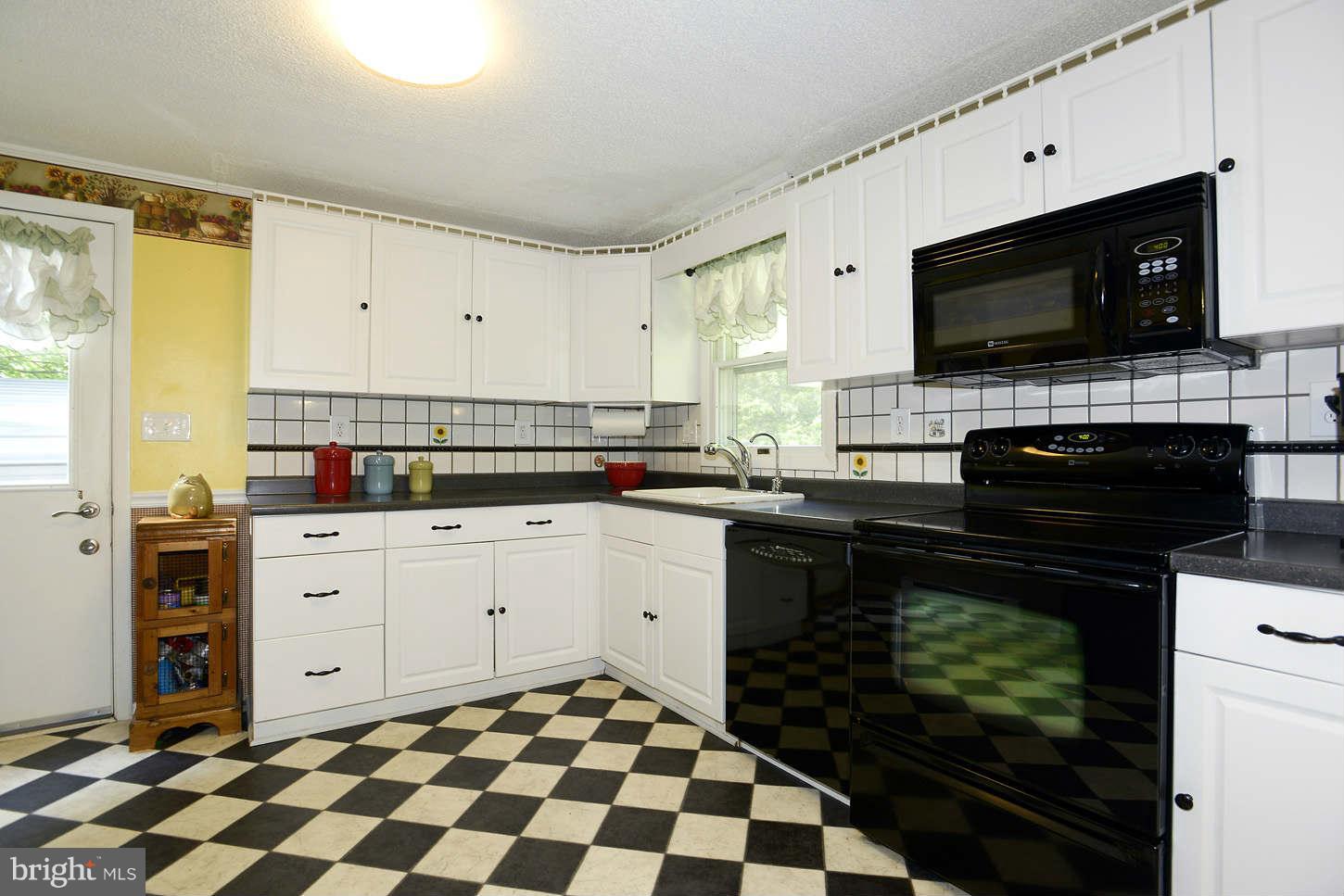 295 North Clear Ridge Road Union Bridge, MD 21791 - Photo 8 of 17 a kitchen with stainless steel appliances a stove a sink and a microwave