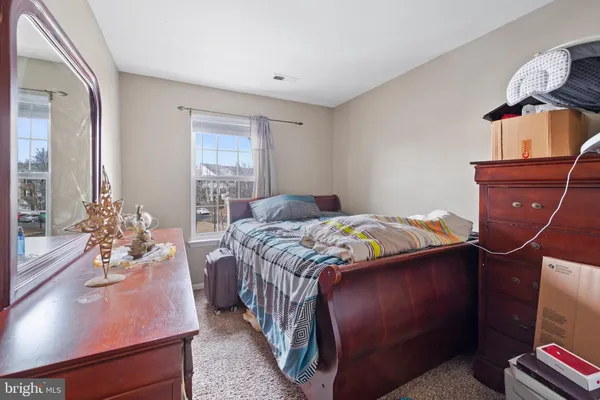 a bedroom with a bed and dresser