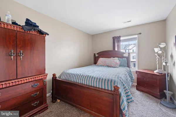 a bedroom with a bed and a mirror