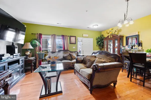 a living room with fireplace furniture and a flat screen tv