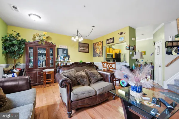 a living room with furniture fireplace and a large window