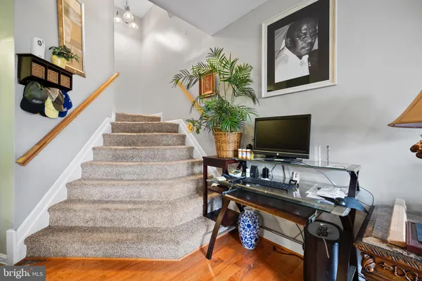a view of entryway and hall with wooden floor