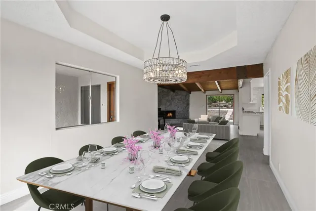 a view of a dining room with furniture and chandelier
