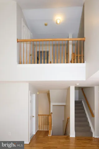 a view of staircase with white walls and railing
