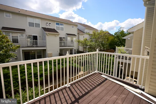 a view of a balcony with wooden floor