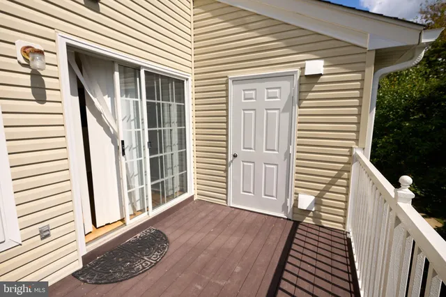 a view of a balcony with wooden floor and stairs