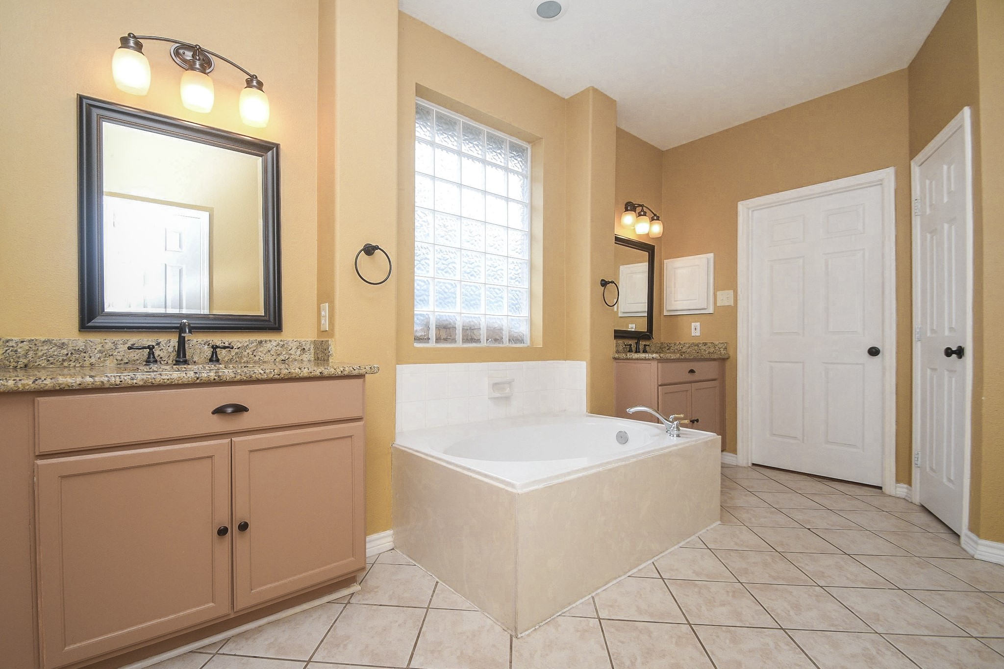 5602 Walkabout Way Katy, TX 77450 - Photo 21 of 33 a bathroom with a bathtub sink and a mirror