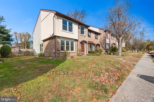 a view of a white house with a yard