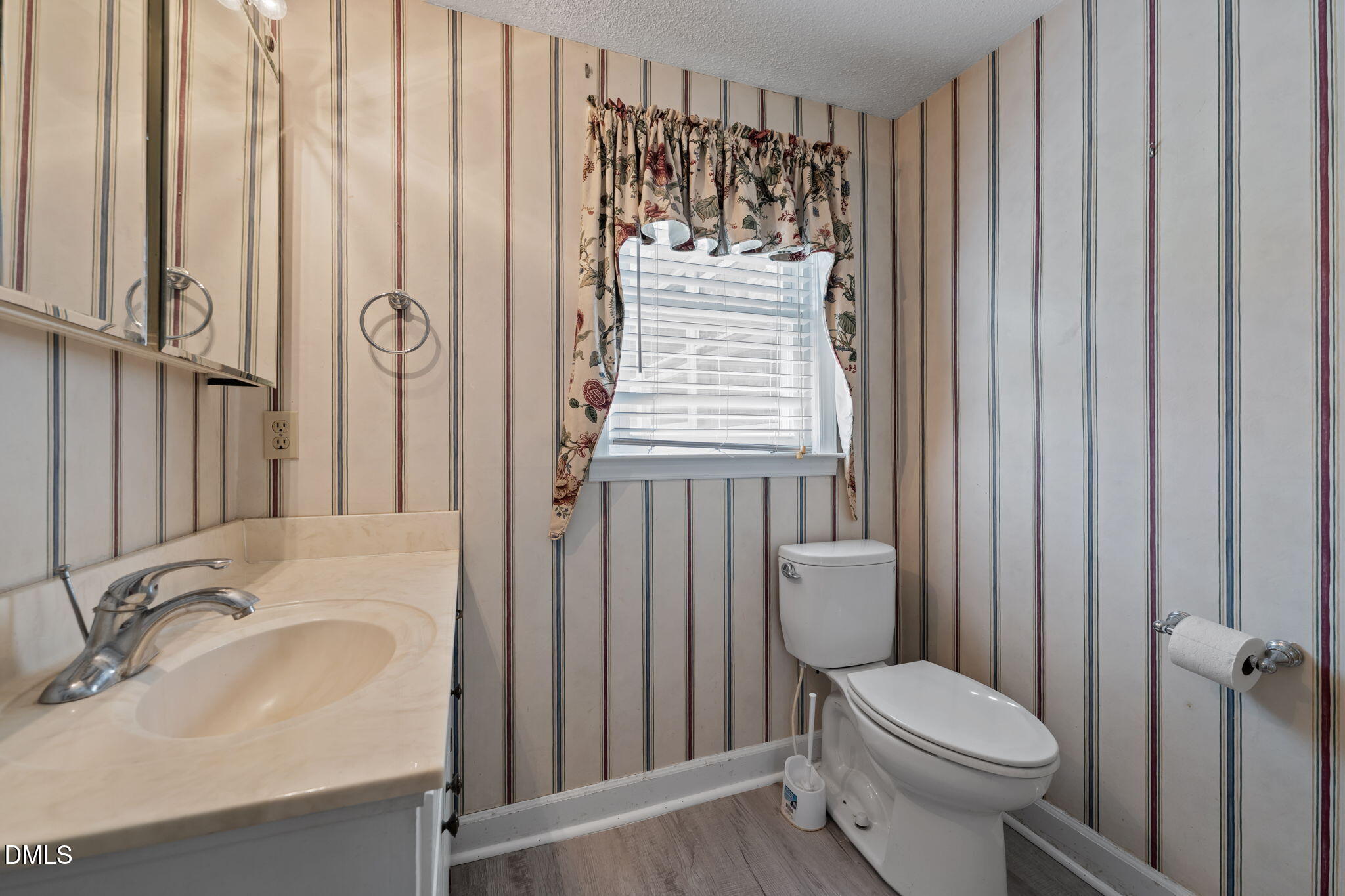 2251 Castle Rock Farm Road Pittsboro, NC 27312 - Photo 19 of 78 a bathroom with a sink a toilet and shower curtain
