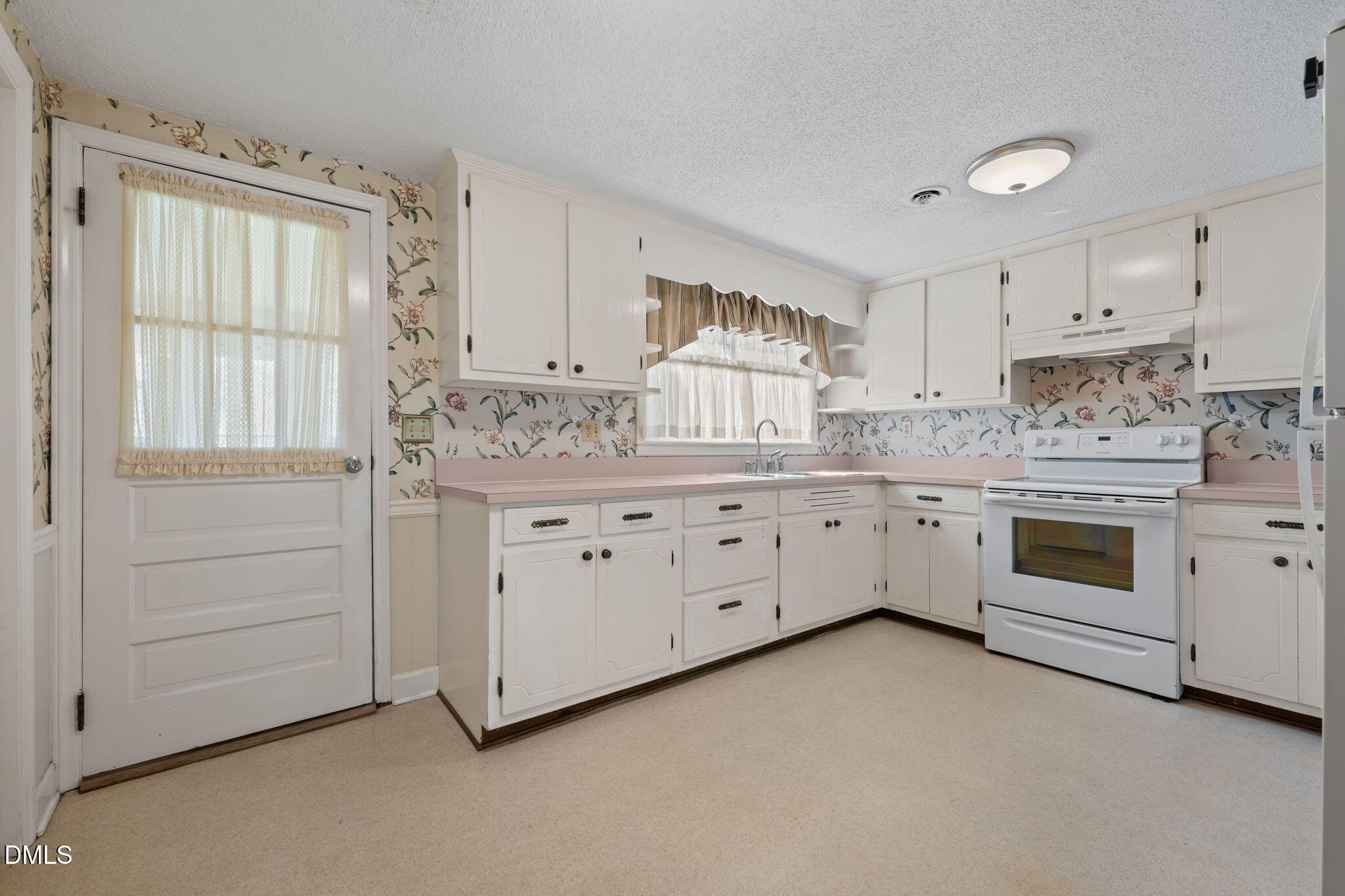 2251 Castle Rock Farm Road Pittsboro, NC 27312 - Photo 24 of 78 a kitchen with white cabinets and white appliances