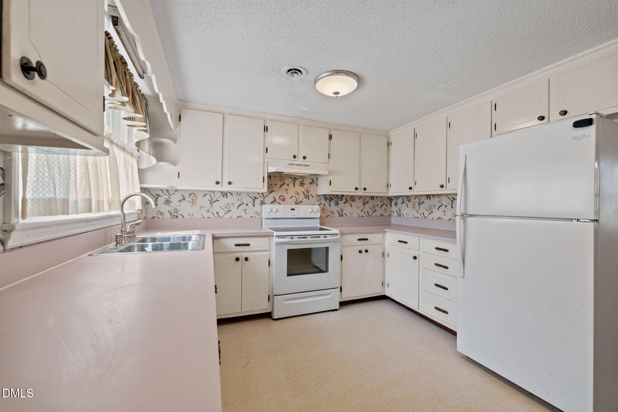 2251 Castle Rock Farm Road Pittsboro, NC 27312 - Photo 25 of 78 a kitchen with granite countertop a refrigerator stove and white cabinets