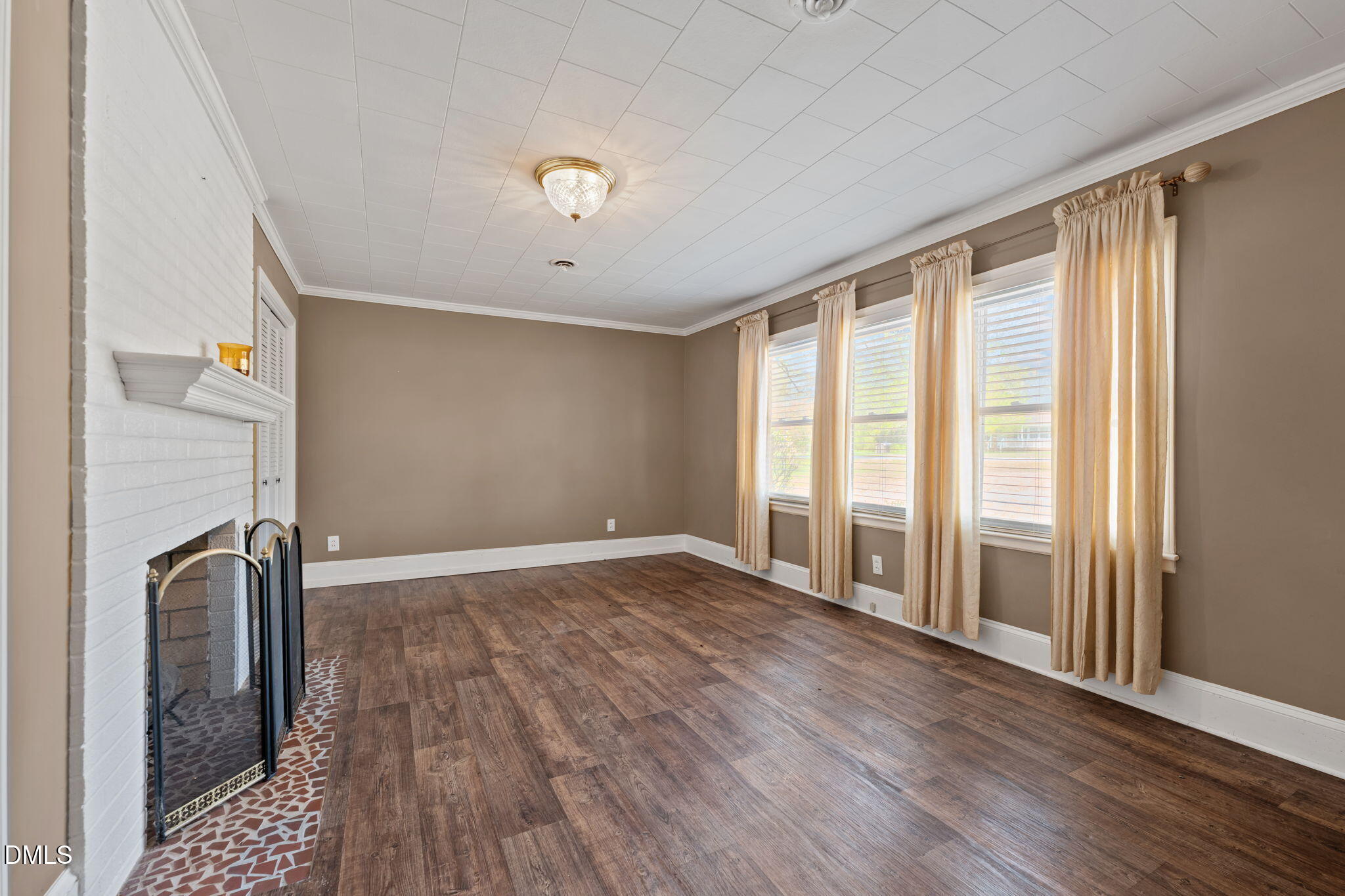 2251 Castle Rock Farm Road Pittsboro, NC 27312 - Photo 27 of 78 an empty room with wooden floor and a fireplace