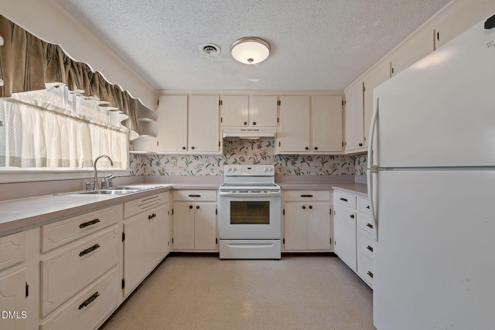 2251 Castle Rock Farm Road Pittsboro, NC 27312 - Photo 38 of 78 a kitchen with granite countertop white cabinets white stainless steel appliances and sink