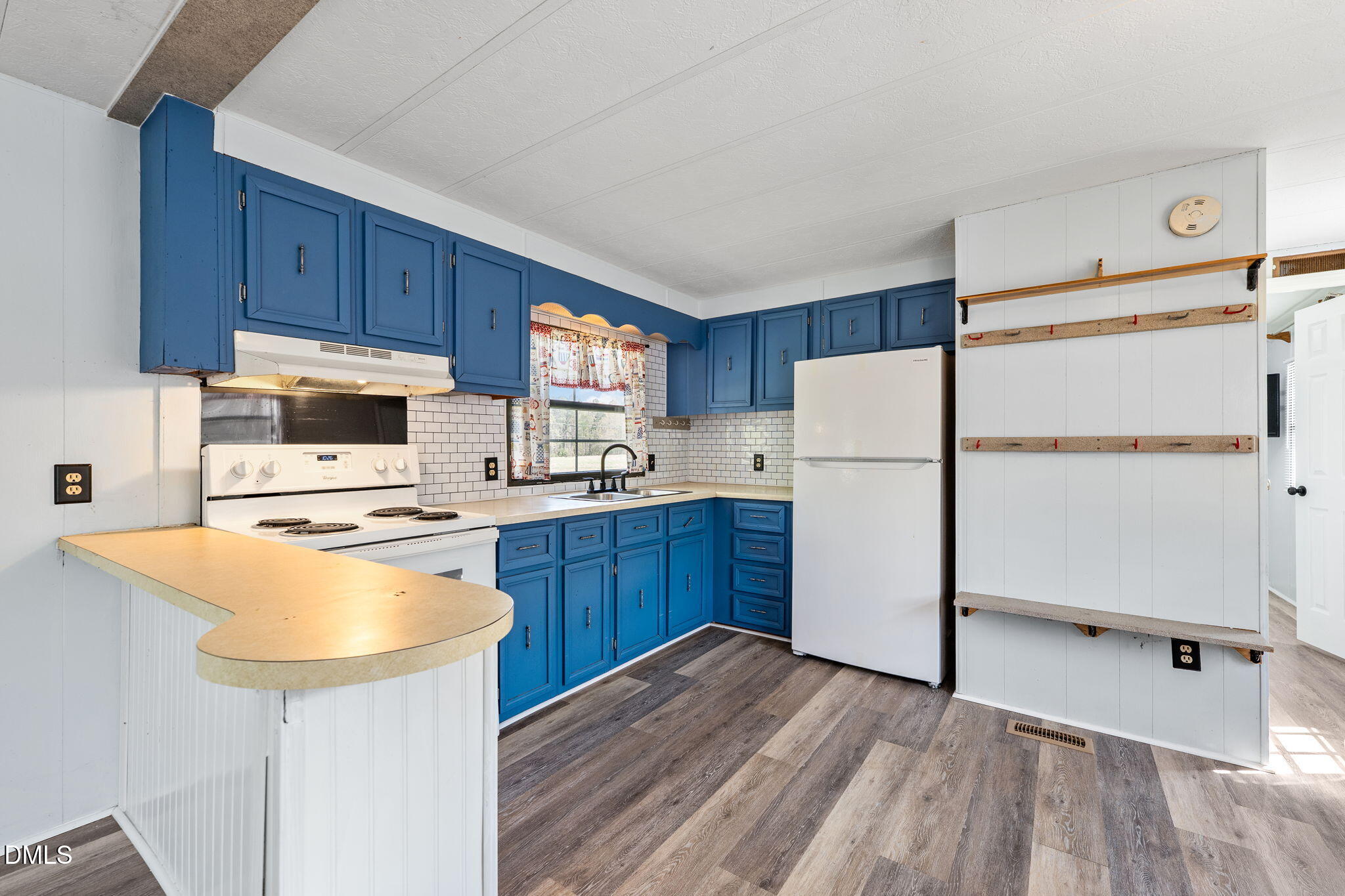 2251 Castle Rock Farm Road Pittsboro, NC 27312 - Photo 62 of 78 a kitchen with a refrigerator a stove top oven a sink dishwasher and wooden cabinets