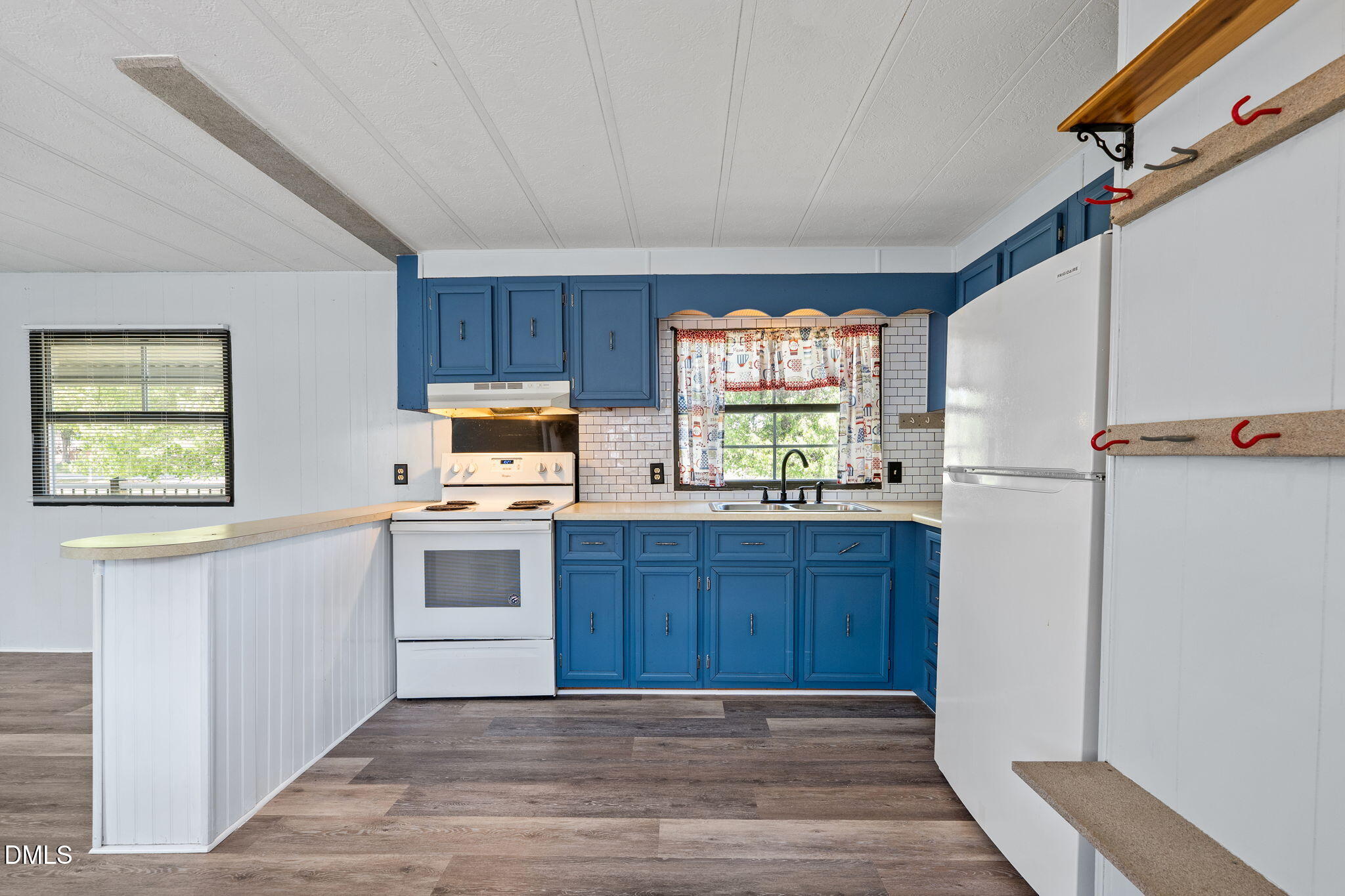 2251 Castle Rock Farm Road Pittsboro, NC 27312 - Photo 63 of 78 a kitchen with granite countertop wooden floors and white stainless steel appliances