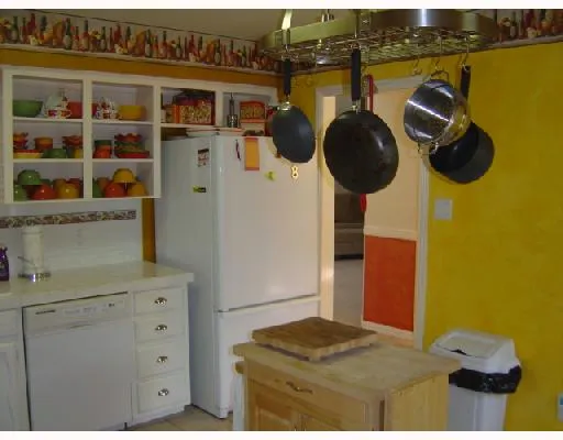 a kitchen with a refrigerator and a stove