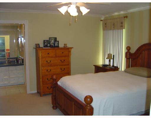 4126 Rippling Creek Drive Corpus Christi, TX 78410 - Photo 5 of 10 a bedroom with a bed and a chandelier