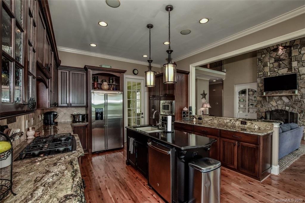 300 Ervin Road Mooresville, NC 28117 - Photo 15 of 32 a kitchen with stainless steel appliances granite countertop a stove oven and a refrigerator