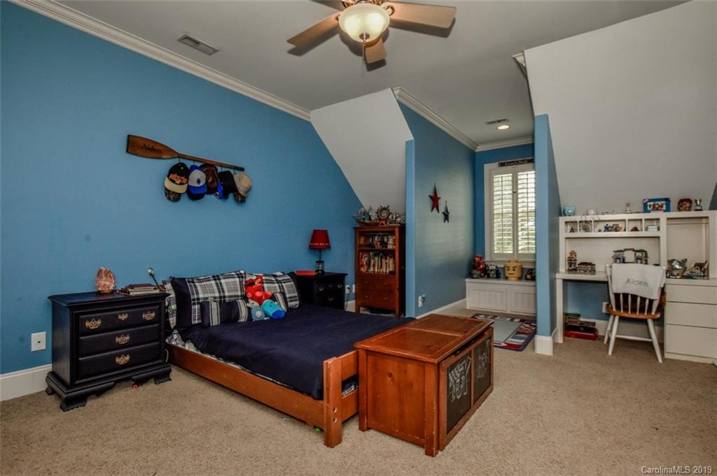300 Ervin Road Mooresville, NC 28117 - Photo 21 of 32 a living room with furniture and a baby crib with rug