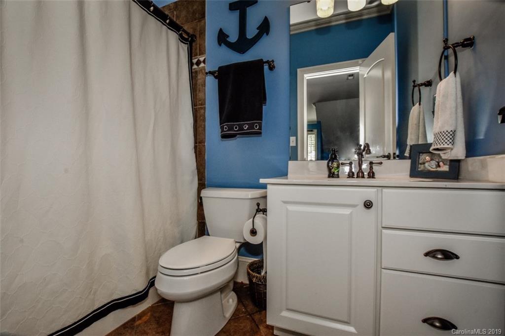 300 Ervin Road Mooresville, NC 28117 - Photo 22 of 32 a bathroom with a toilet a sink and a mirror