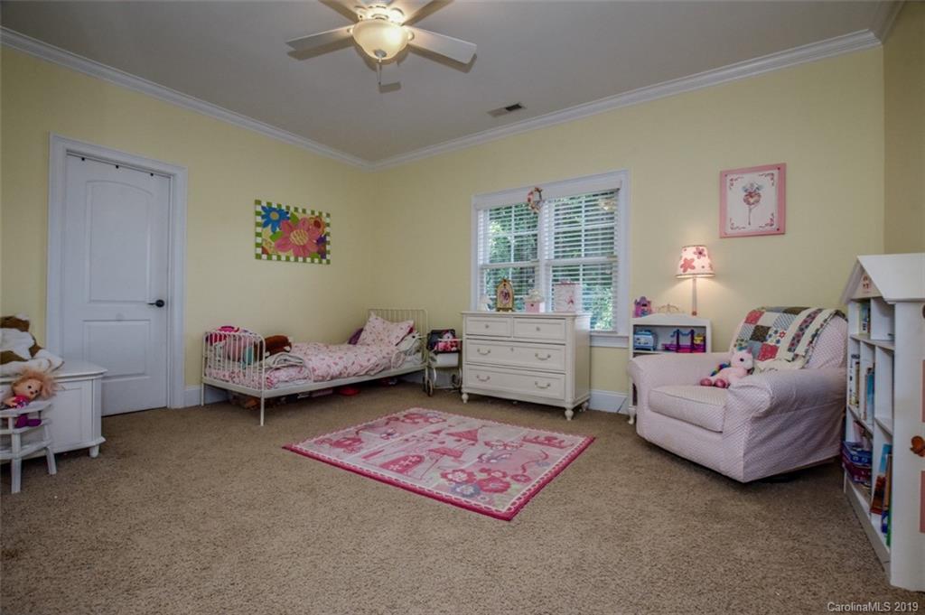 300 Ervin Road Mooresville, NC 28117 - Photo 23 of 32 a bedroom with furniture and a chandelier