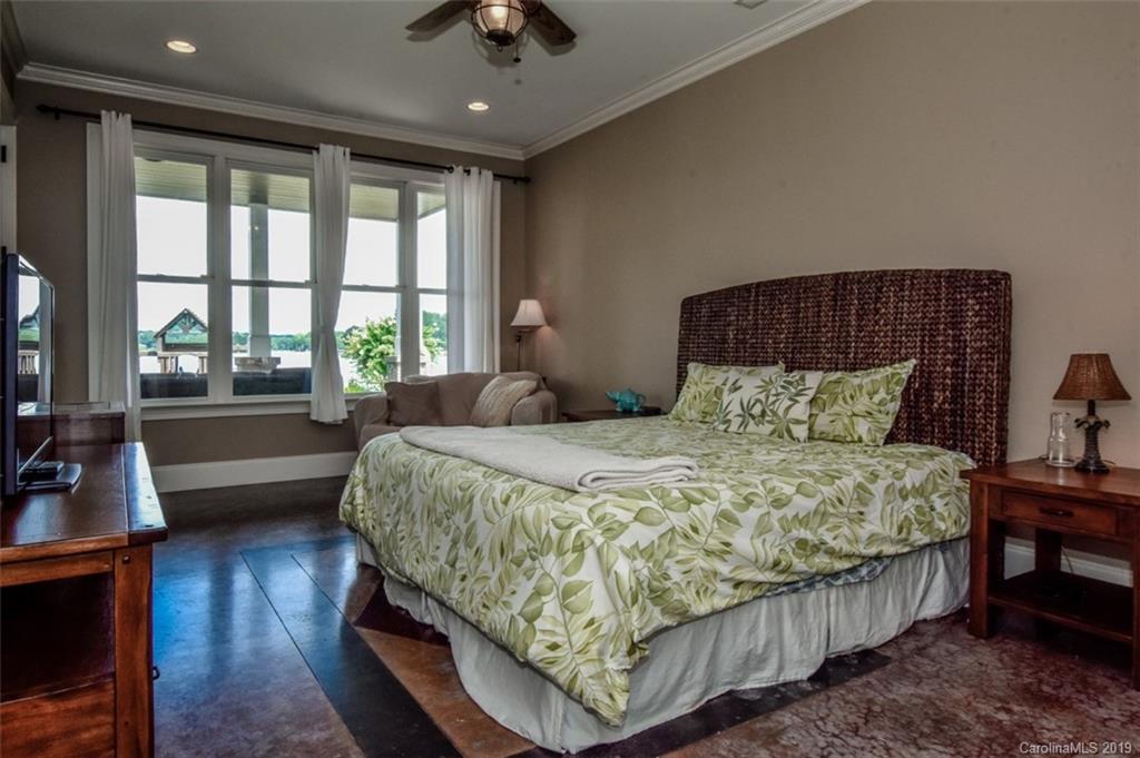300 Ervin Road Mooresville, NC 28117 - Photo 26 of 32 a bedroom with a bed a couch and a large window with wooden floor