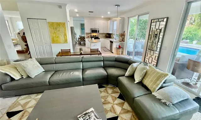 a living room with furniture and a large window