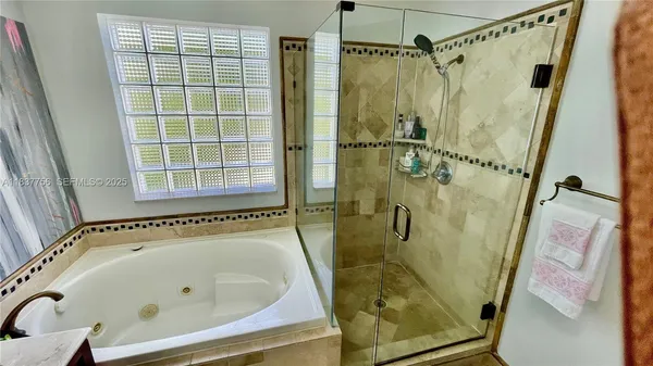 a bathroom with a bath tub and shower
